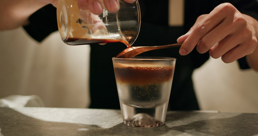 Pour espresso coffee into tonic water, mock tail beverage